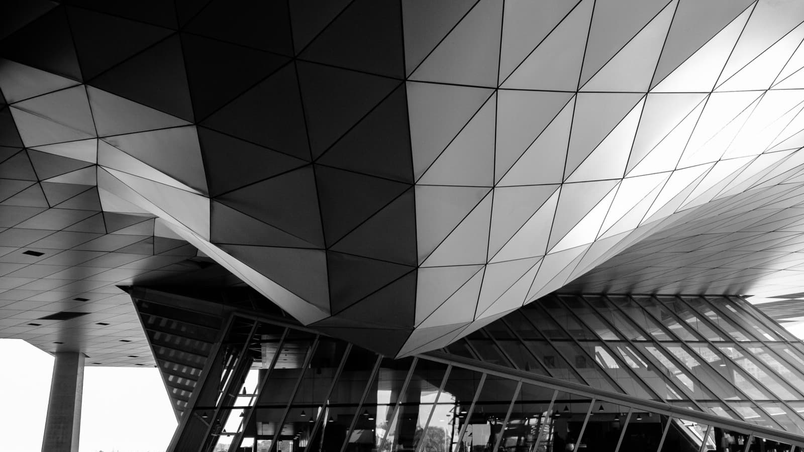 The steel and glass frame of a building seen from below